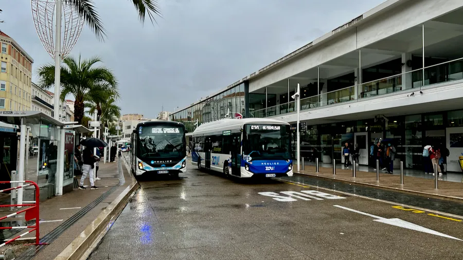 Local buses at the Cannes bus station on a rainy day