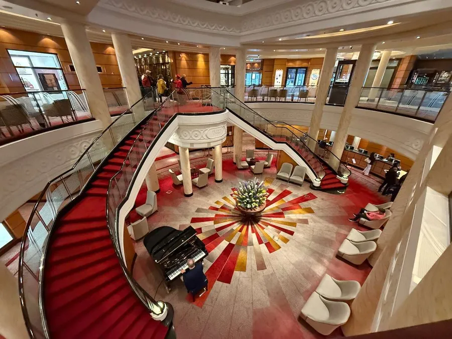 Stunning grand lobby on QM2 decked out in red and gold