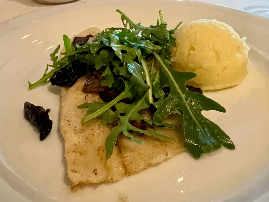A fish, potato and salad dish from the Versailles dining room on Norwegian Star