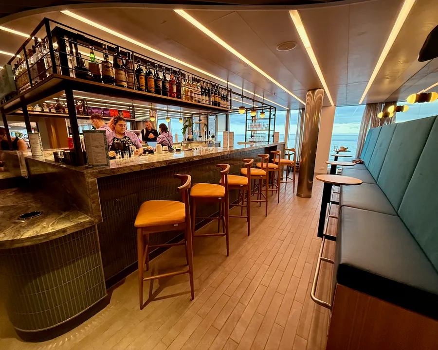 Grounds Club at Scarlet Lady cruise ship showing a long bar in a coffee shop cum cocktail bar