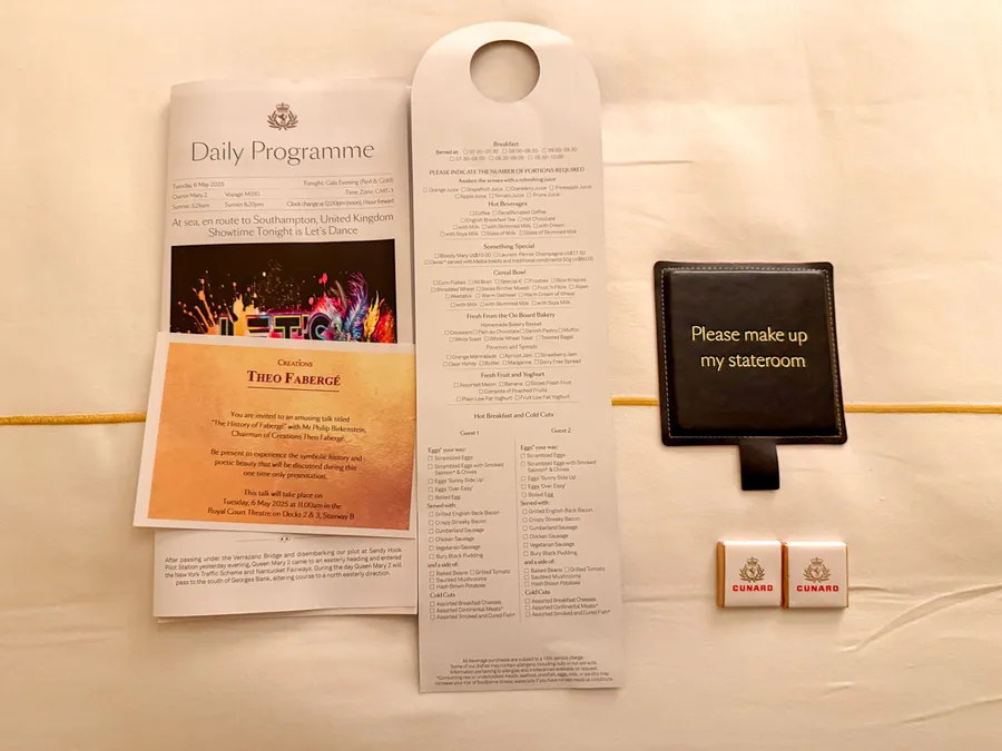 Items left on the bed after turndown service including chocolates and a breakfast menu.